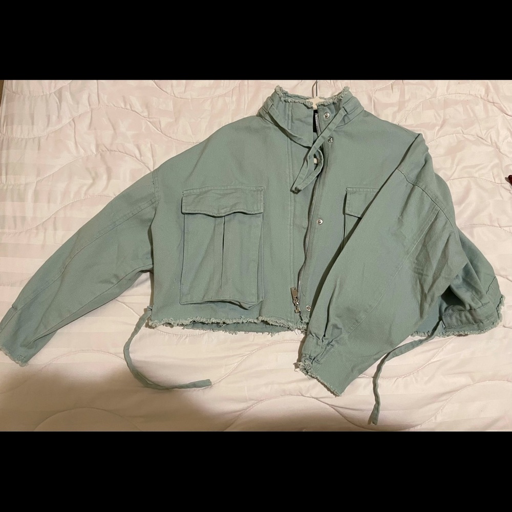 Baggy mint green jacket with two big pockets in the front.